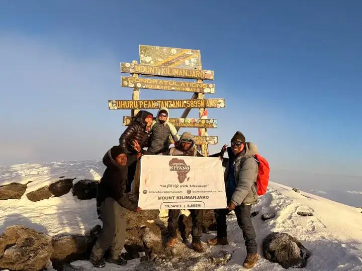 Kitano Tours climbers celebrating at Uhuru Peak on Mount Kilimanjaro